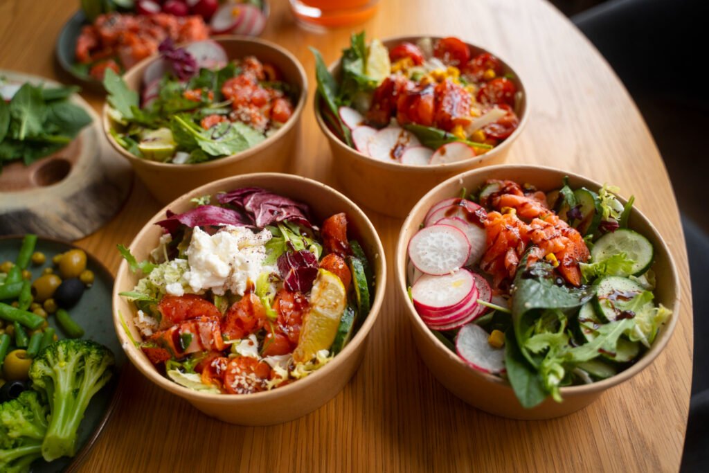 Several salad bowls laid out together on a table to share
