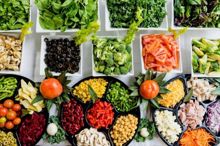 Trays of chopped salad ingredients laid out ready to be built into a bowl